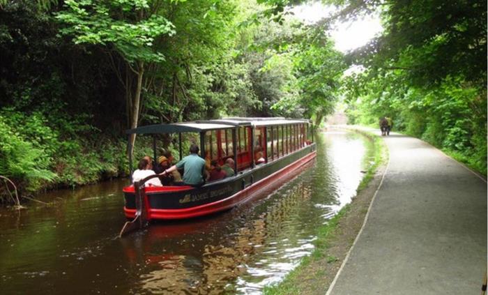 A scenic view of Llagollen Wharf's horse drawn boats as it glides gently through the water.